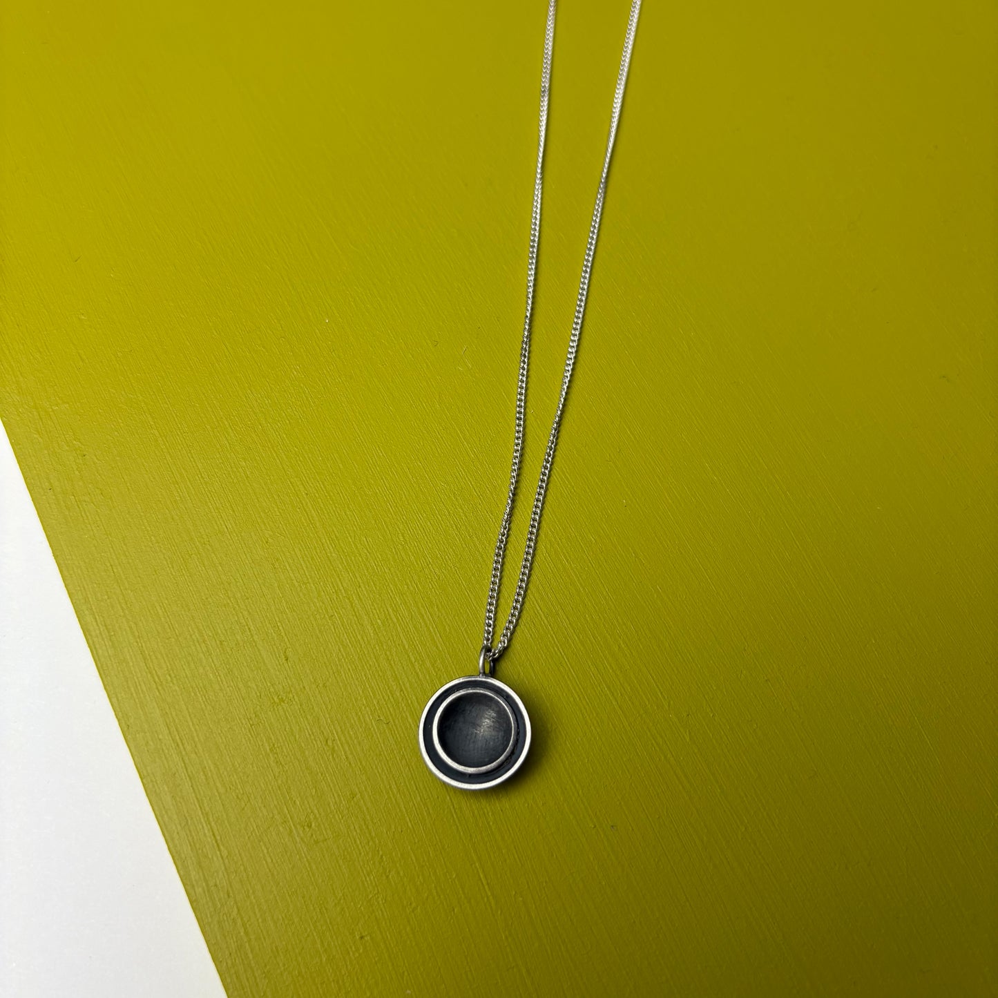 Oxidised Disk Pendant by Will Sharp
